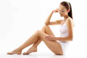 Woman smiling at her smooth legs after Aveli cellulite treatment in Boca Raton, FL