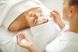 Woman relaxing with eyes closed why getting a facial in Boca Raton, FL