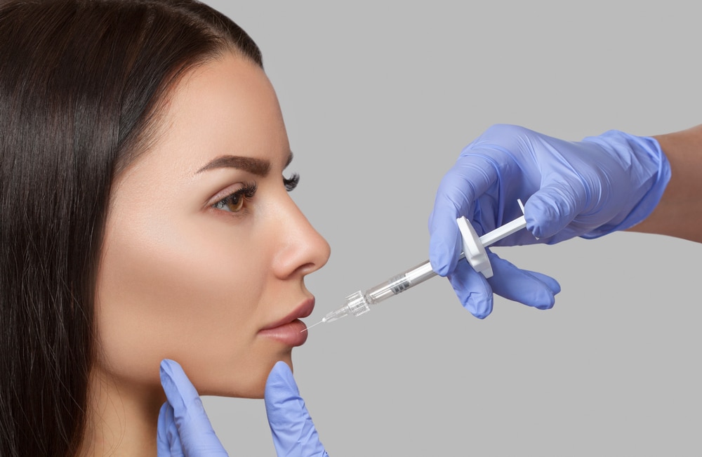 The,Doctor,Cosmetologist,Makes,Lip,Augmentation,Procedure,Of,A,Beautiful
